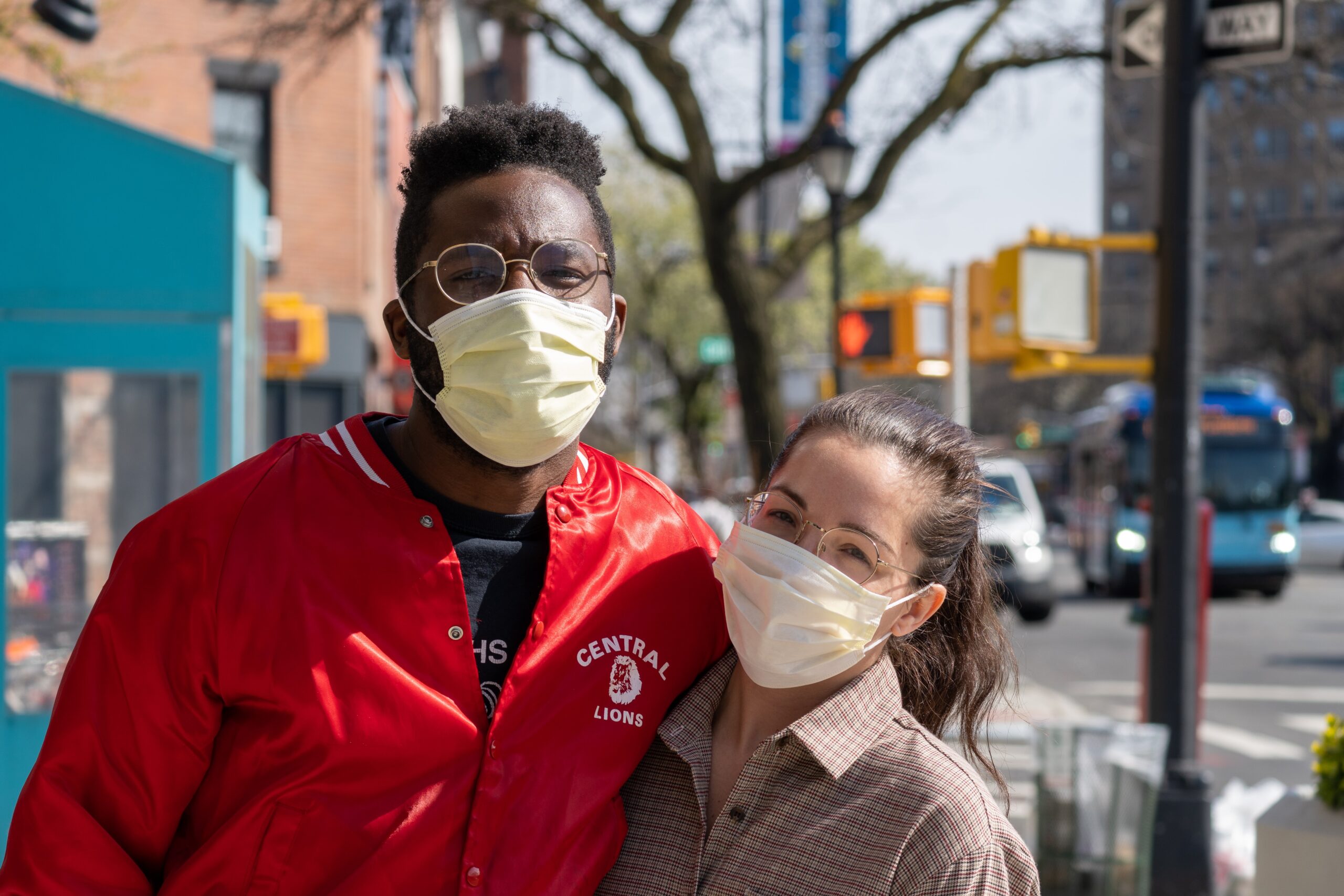Two individuals on a street with face masks on